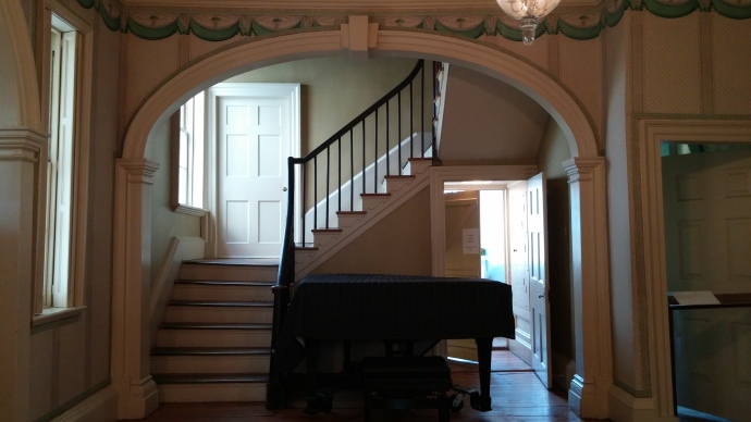 The staircase and hardwood floors that you see here are original. The piano was added much later, and is sometimes used for performances.